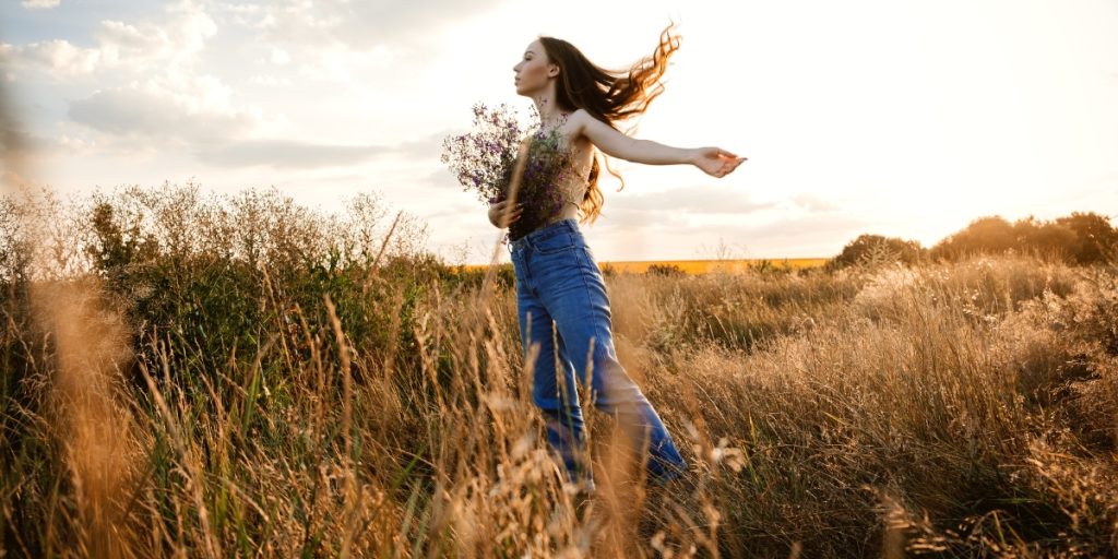 The 7 Stages Of A Spiritual Awakening woman standing in a field