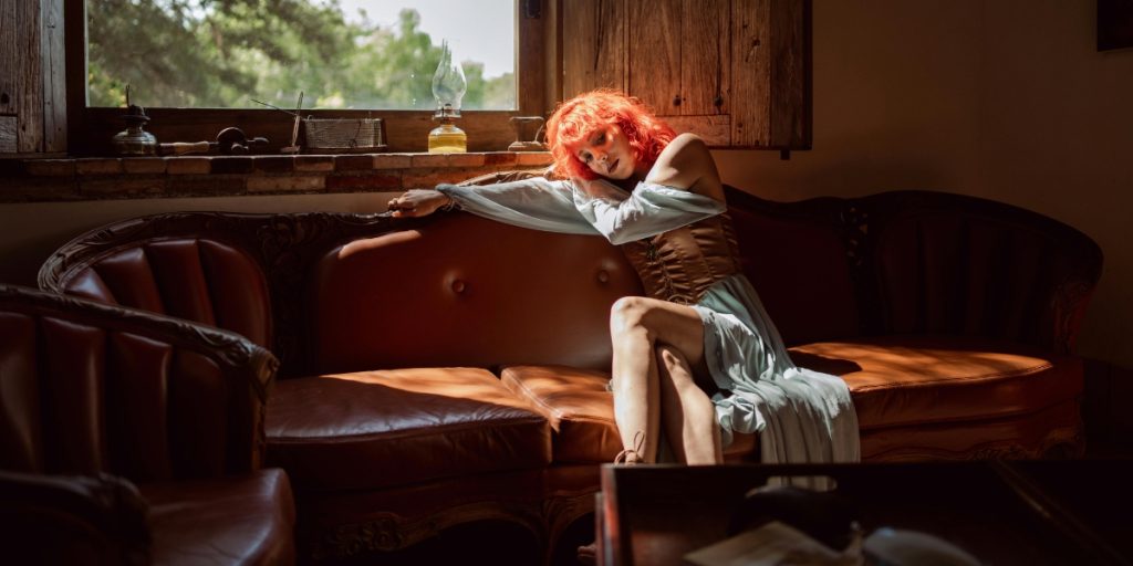 Woman with red hair on a couch